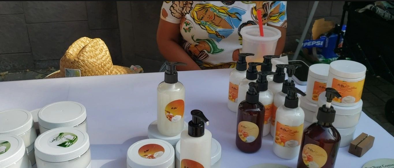 A vendor table of body butters and lotions at a BIYC First Sundays market