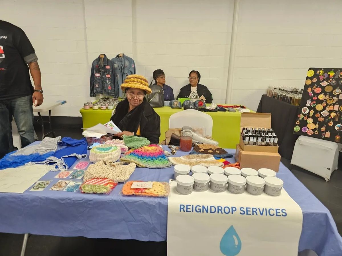 A vendor at the Reign Drop Services table